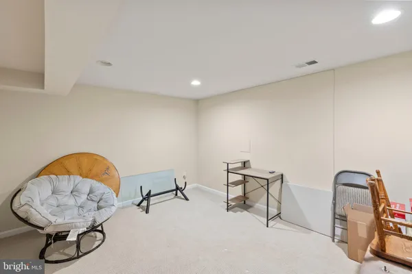 a bathroom with a granite countertop sink and a toilet