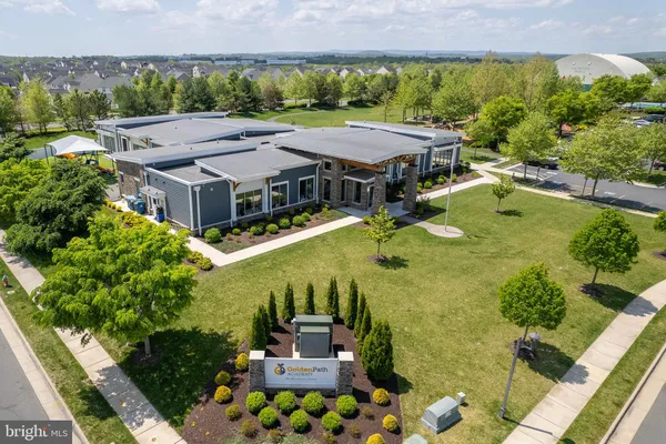 an aerial view of a house with a garden and lake view