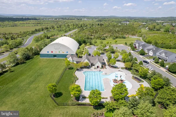 an aerial view of a house with a garden and lake view