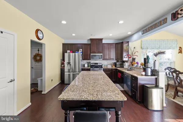 a large kitchen with lots of counter space and wooden floor