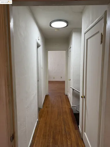 a view of a hallway with wooden floor