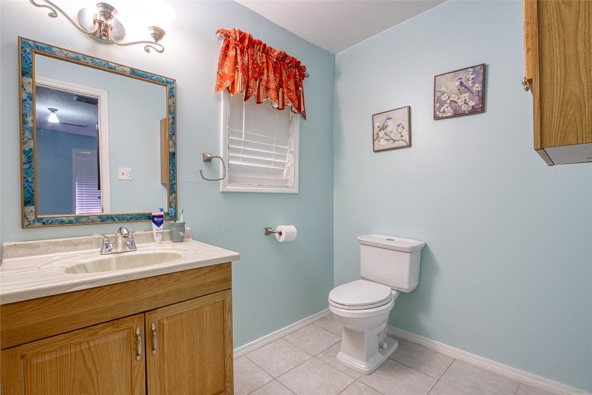 13117 Player Street Houston, TX 77045 - Photo 15 of 36 a bathroom with a toilet sink and mirror