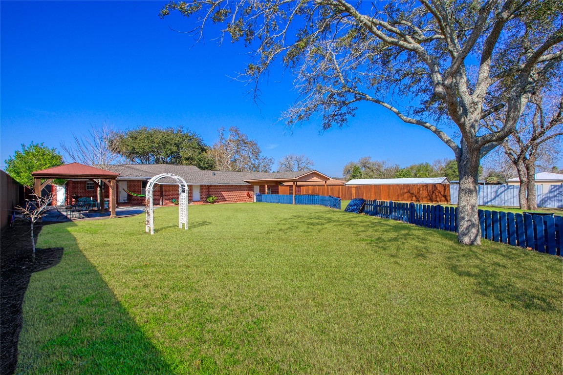 13117 Player Street Houston, TX 77045 - Photo 23 of 36 a view of an house with backyard space and balcony