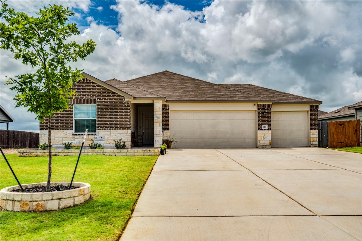 389 Salt Springs Road Kyle, TX 78640 - Photo 1 of 30 A well-maintained lawn and concrete driveway lead to this charming brick and stone residence.