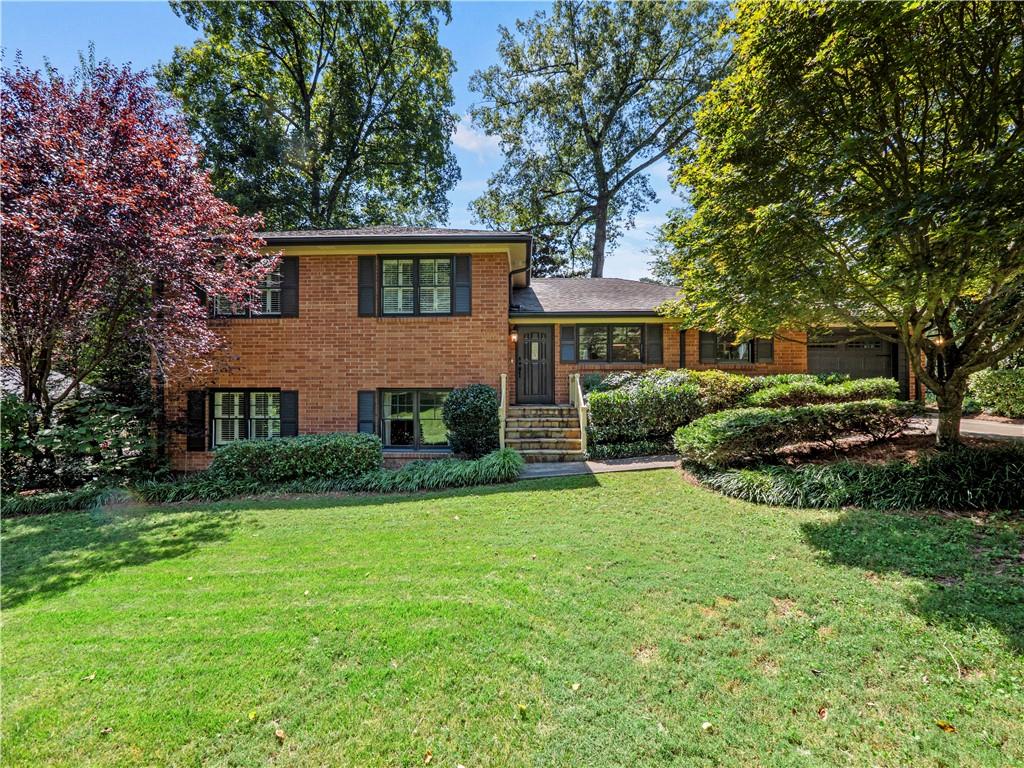 2077 Trailmark Drive Decatur, GA 30033 - Photo 1 of 1 a front view of a house with a yard and trees