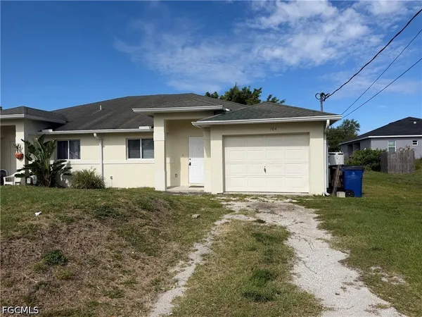 a front view of a house with a yard and garage