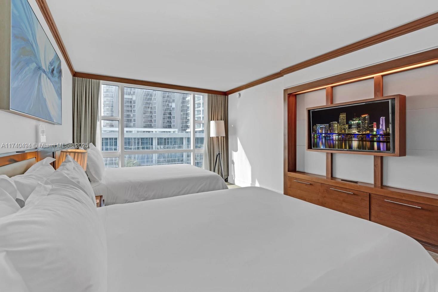 6801 Collins Avenue, Unit 608 Miami Beach, FL 33141 - Photo 20 of 24 a bedroom with a bed and a large window