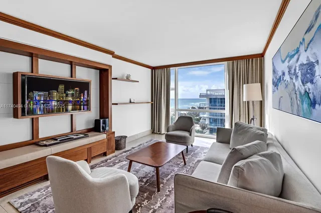 a living room with furniture and a floor to ceiling window