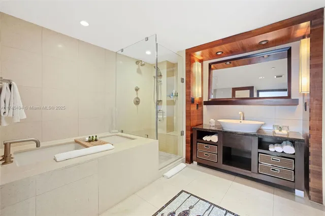 a bathroom with a double vanity sink mirror and shower