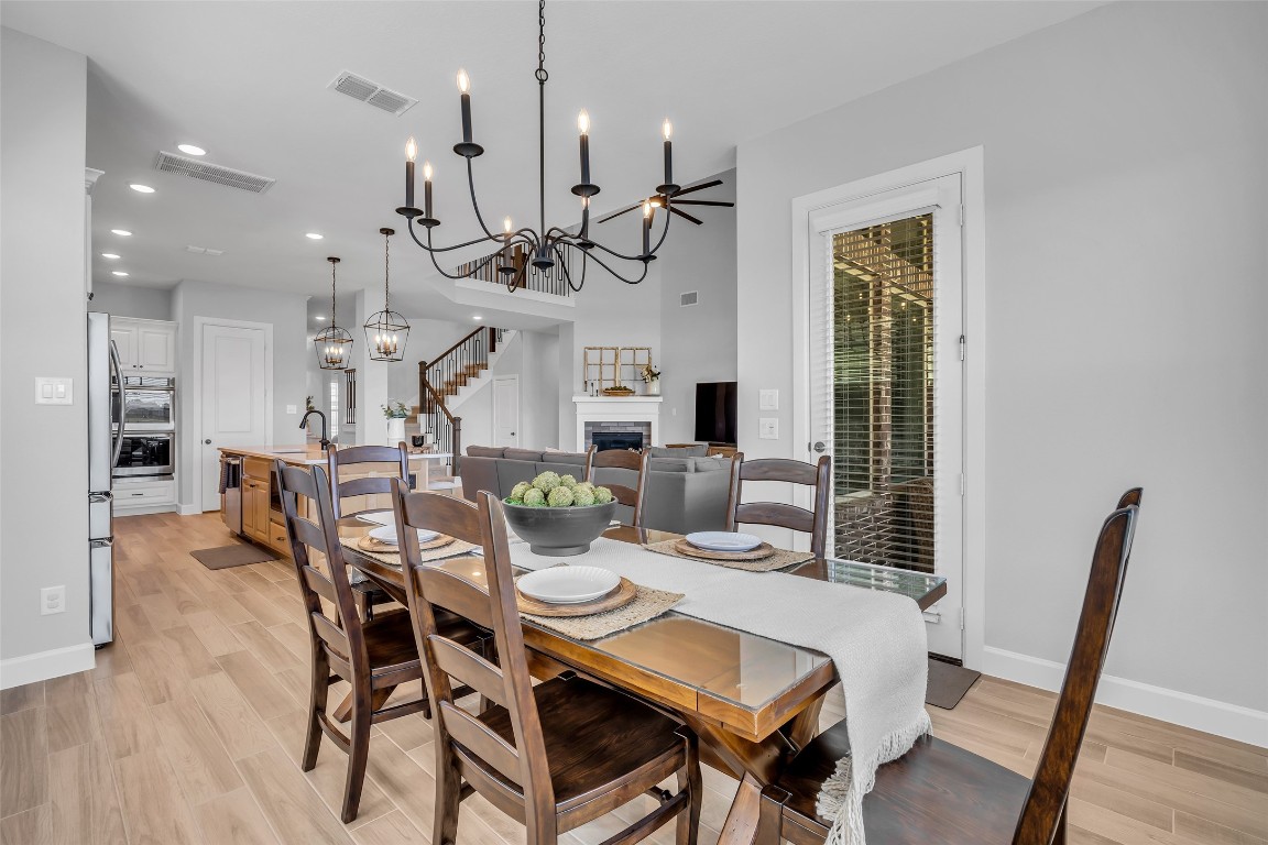 32442 Soaring Willow Way Conroe, TX 77385 - Photo 10 of 45 a view of a dining room with furniture wooden floor and chandelier