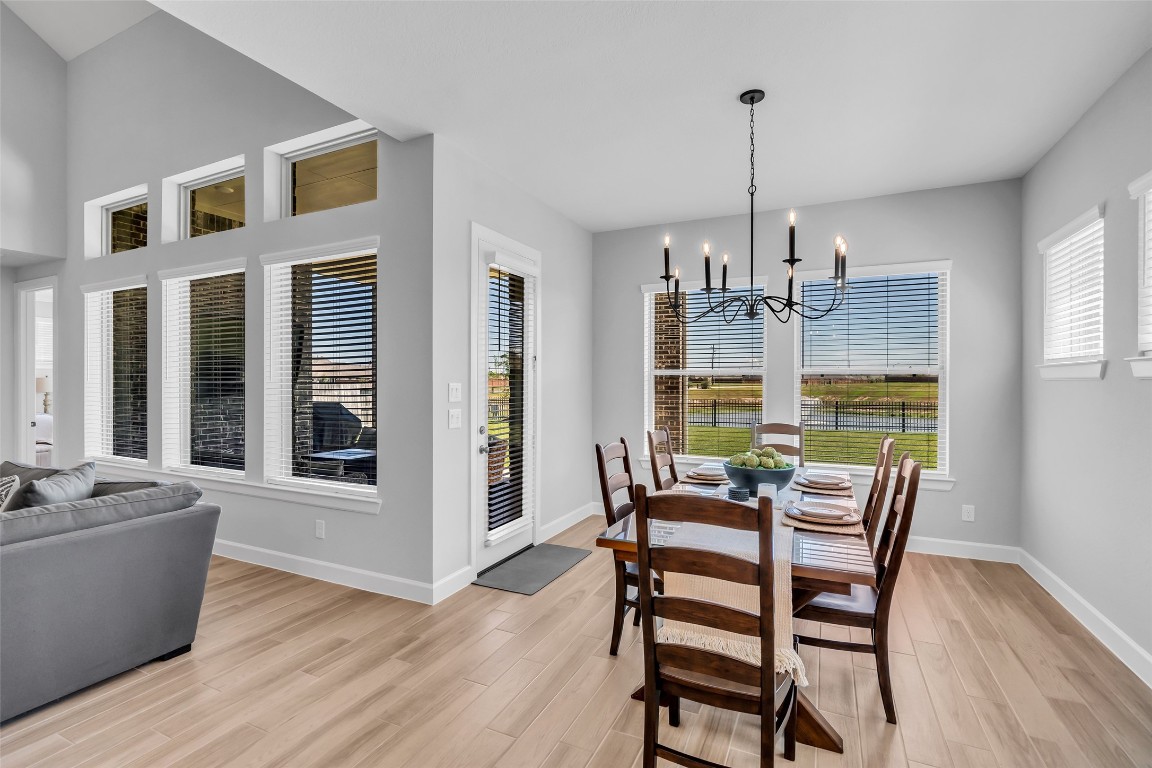 32442 Soaring Willow Way Conroe, TX 77385 - Photo 12 of 45 a view of a dining room with furniture window and wooden floor