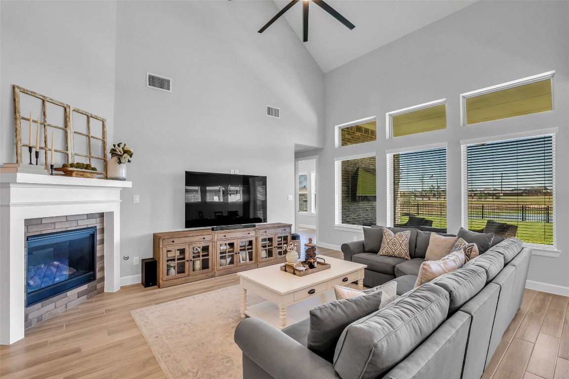 32442 Soaring Willow Way Conroe, TX 77385 - Photo 15 of 45 a living room with furniture a fireplace and a flat screen tv