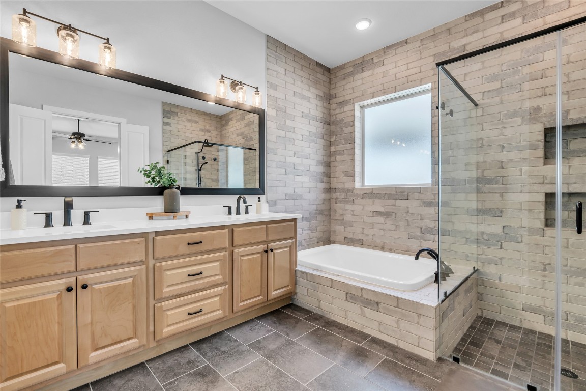 32442 Soaring Willow Way Conroe, TX 77385 - Photo 20 of 45 a bathroom with a tub sink and mirror