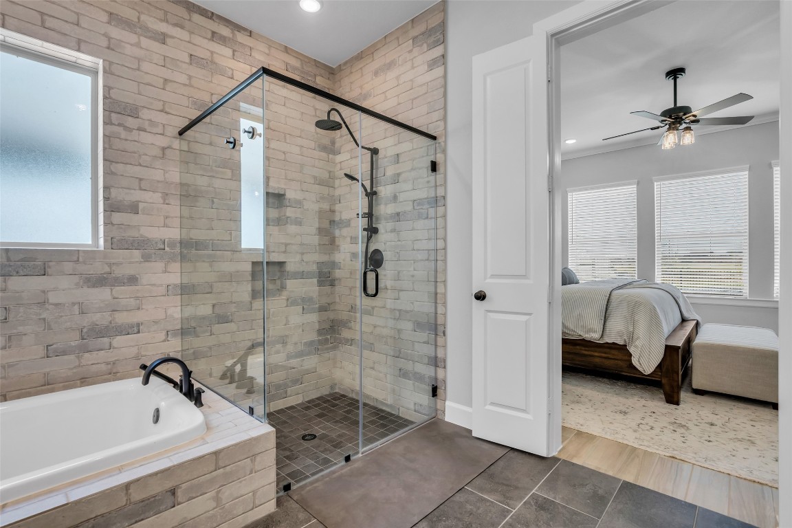 32442 Soaring Willow Way Conroe, TX 77385 - Photo 21 of 45 a bathroom with a tub shower and window