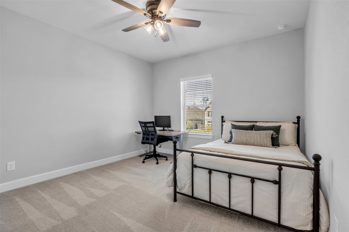 32442 Soaring Willow Way Conroe, TX 77385 - Photo 27 of 45 a bedroom with a bed table and a window