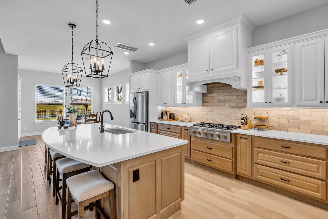 32442 Soaring Willow Way Conroe, TX 77385 - Photo 3 of 45 The chef-inspired kitchen is a true centerpiece, featuring an oversized presentation island, walk-in pantry, and abundant storage-designed for both effortless entertaining and everyday elegance.