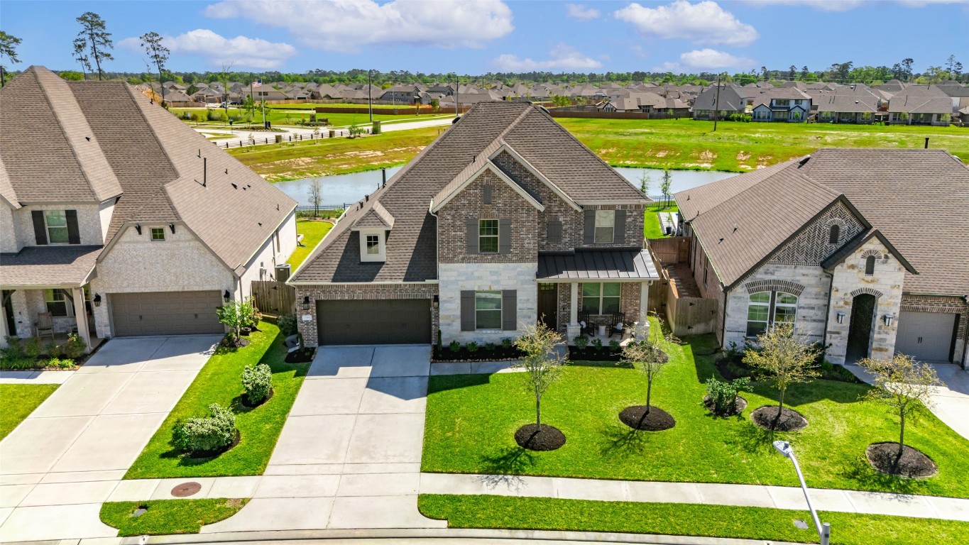 32442 Soaring Willow Way Conroe, TX 77385 - Photo 40 of 45 an aerial view of a house with swimming pool and a yard