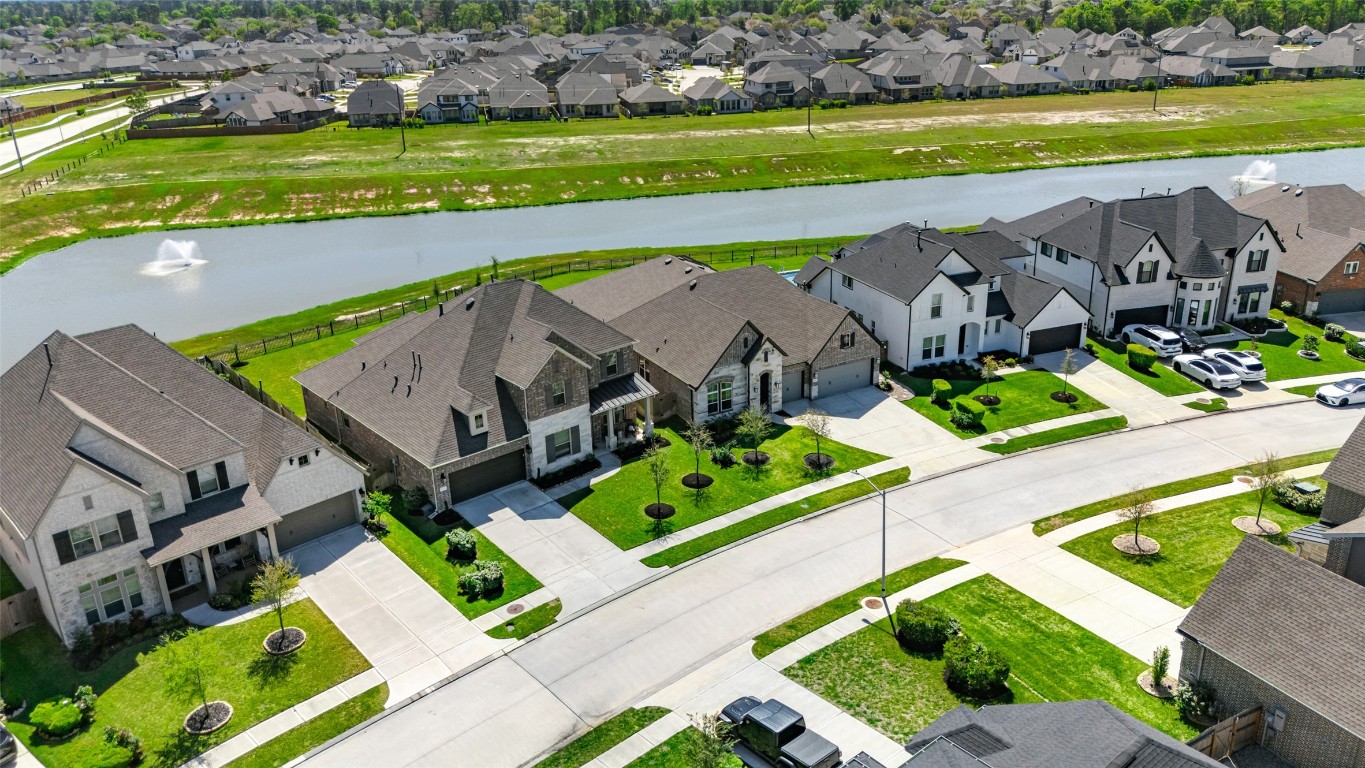 32442 Soaring Willow Way Conroe, TX 77385 - Photo 41 of 45 an aerial view of a house with a garden and lake view