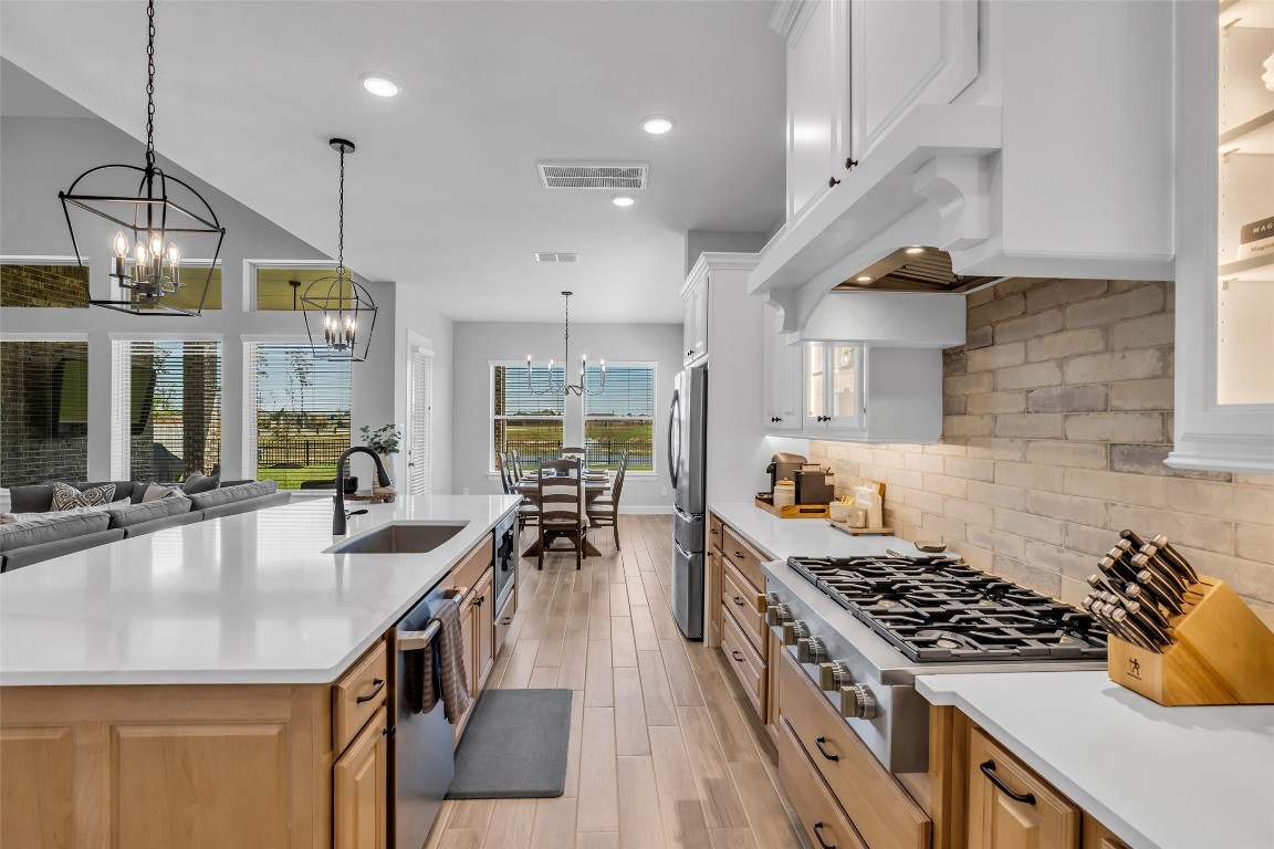 32442 Soaring Willow Way Conroe, TX 77385 - Photo 5 of 45 a kitchen with kitchen island a counter space a sink stainless steel appliances and cabinets