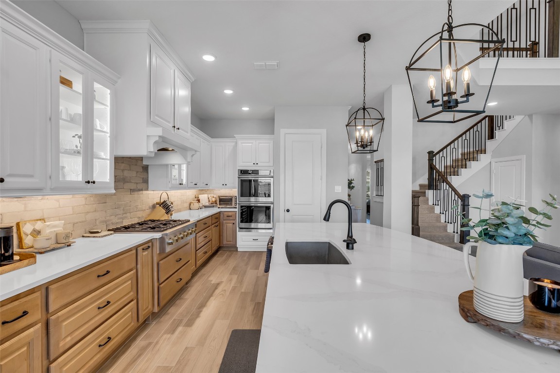 32442 Soaring Willow Way Conroe, TX 77385 - Photo 6 of 45 a kitchen with sink a stove and cabinets