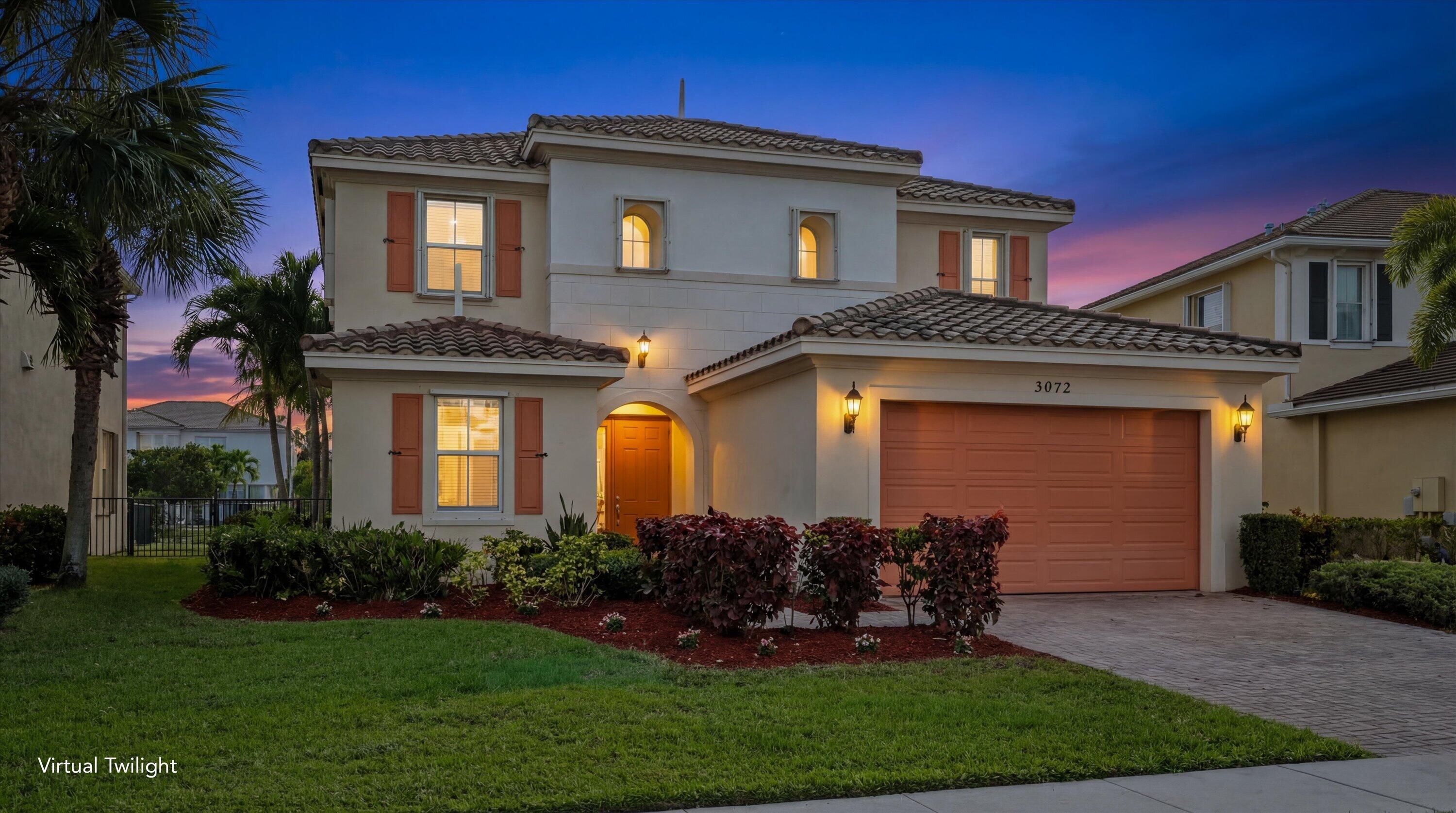 3072 Payson Way Wellington, FL 33414 - Photo 1 of 43 a front view of a house with garden