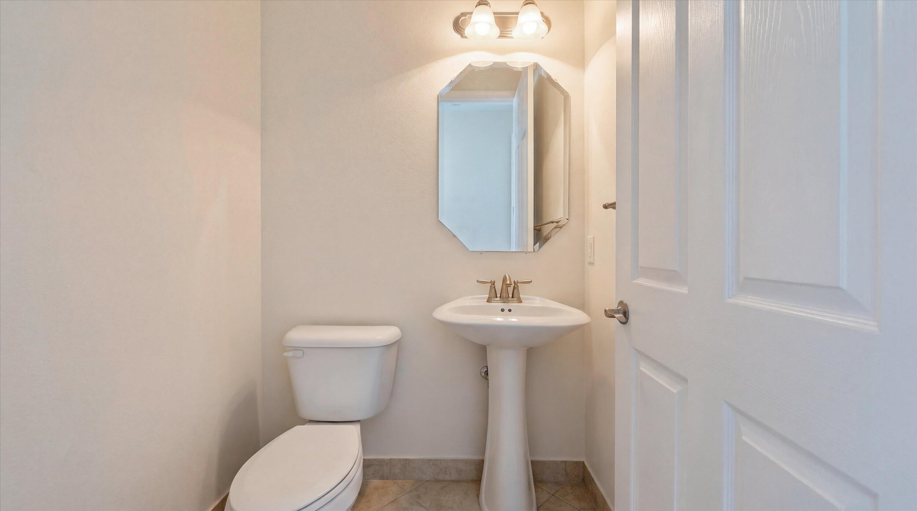 3072 Payson Way Wellington, FL 33414 - Photo 12 of 43 a bathroom with a toilet sink and mirror