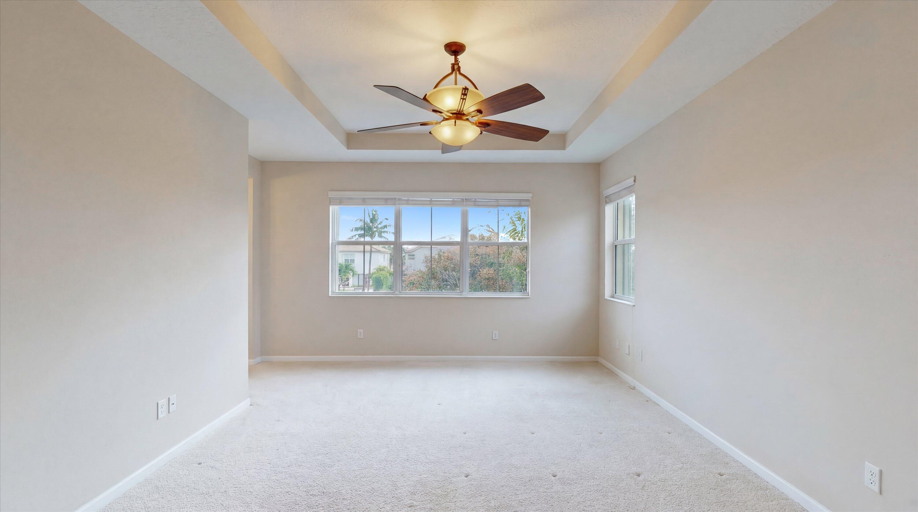 3072 Payson Way Wellington, FL 33414 - Photo 18 of 43 an empty room that has a window and a ceiling fan