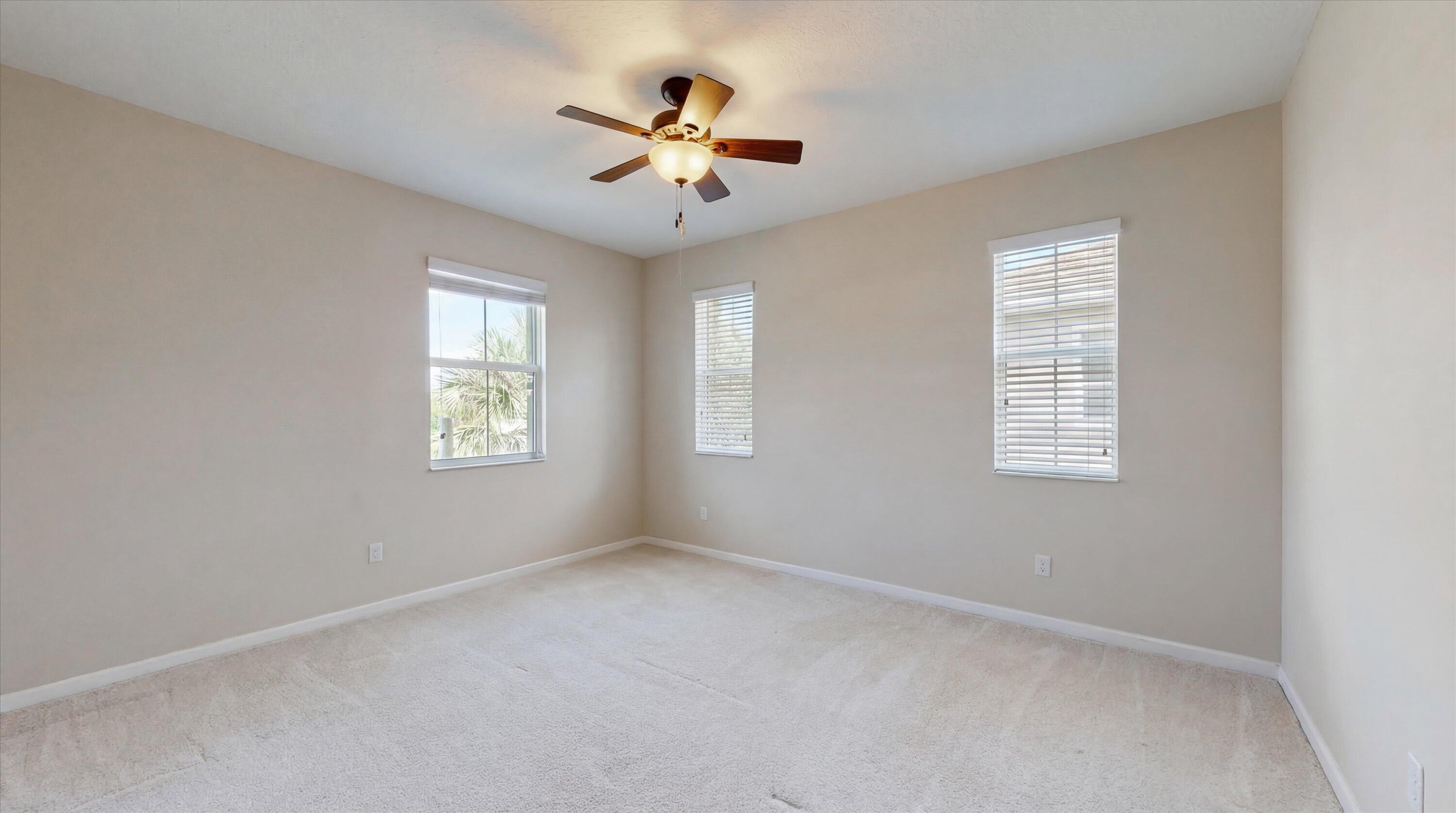 3072 Payson Way Wellington, FL 33414 - Photo 22 of 43 an empty room with windows and fan