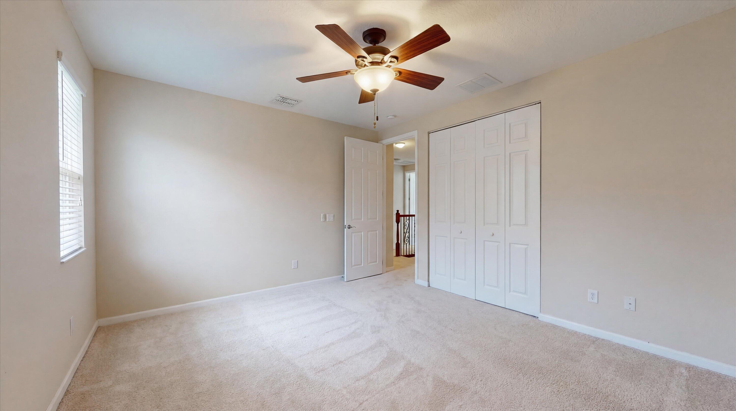 3072 Payson Way Wellington, FL 33414 - Photo 23 of 43 an empty room with ceiling fan and window