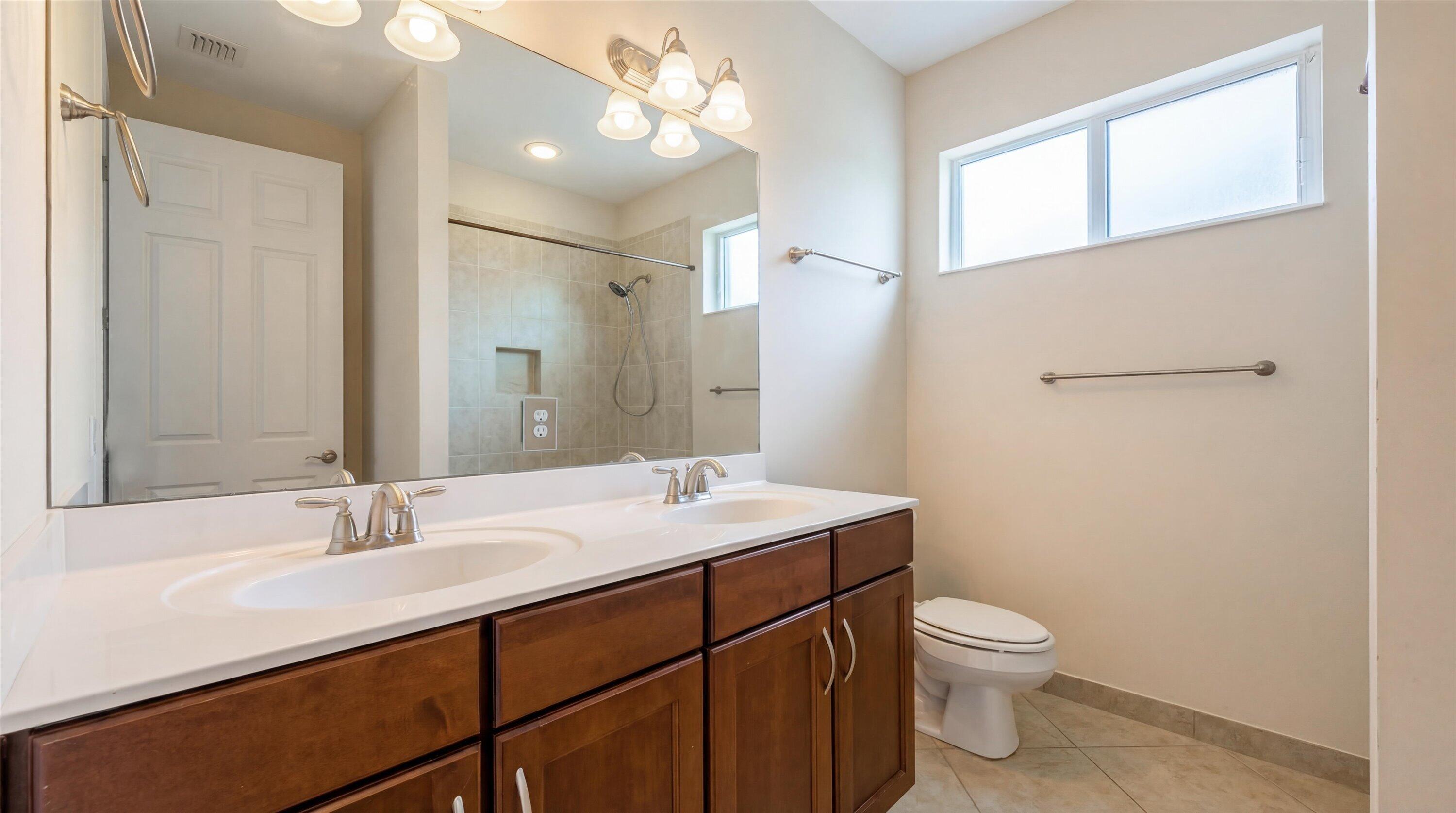 3072 Payson Way Wellington, FL 33414 - Photo 24 of 43 a bathroom with a sink a toilet and mirror