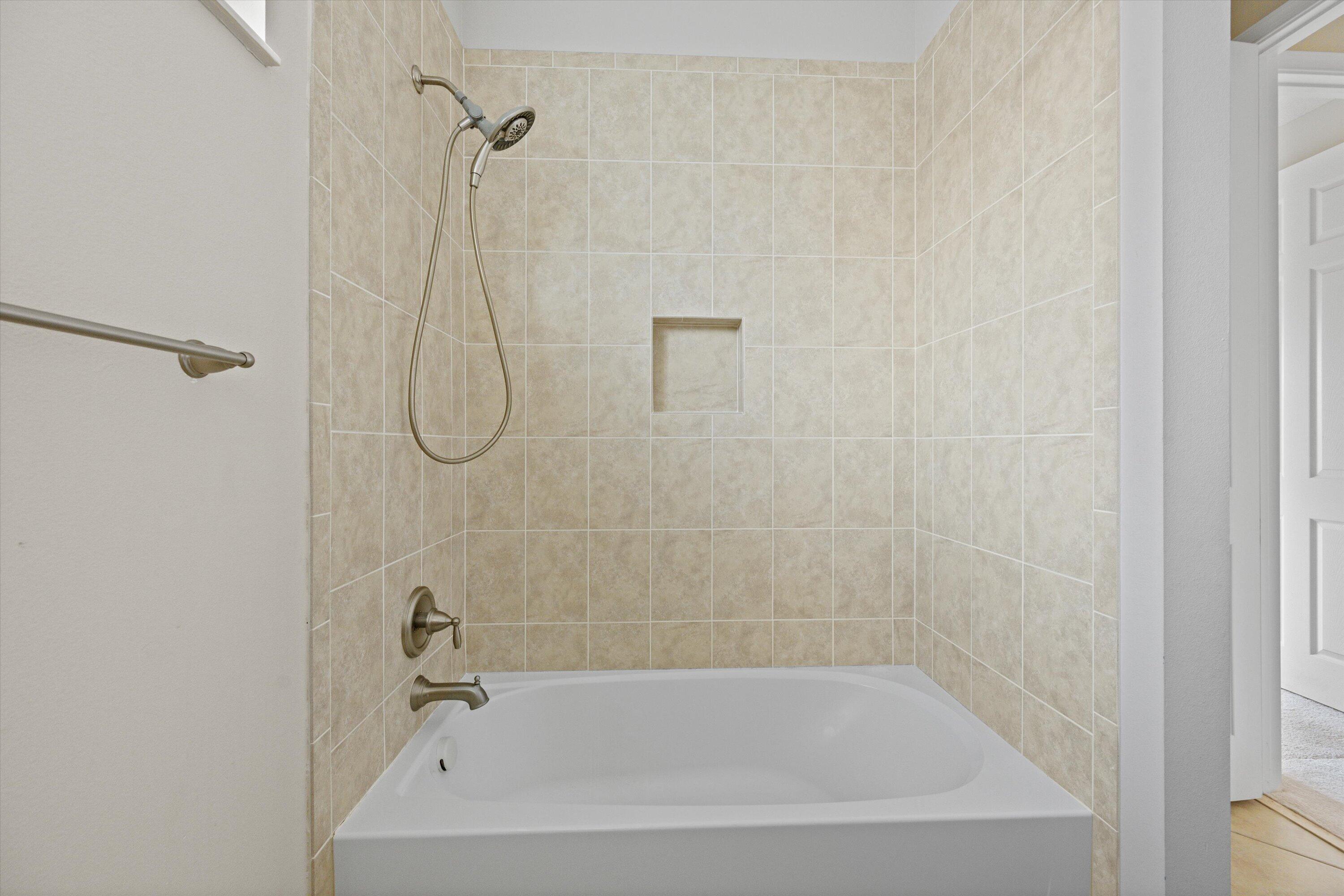 3072 Payson Way Wellington, FL 33414 - Photo 25 of 43 a bathroom with a bath tub with a shower