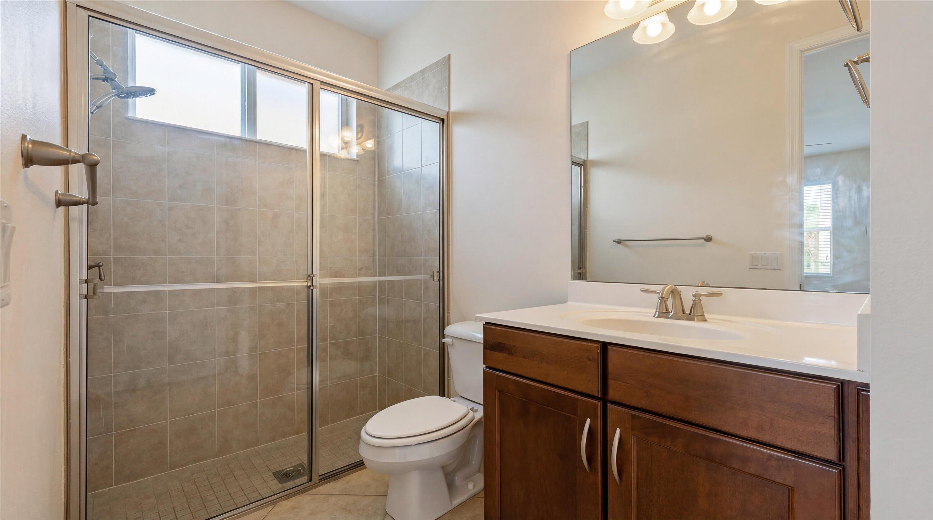 3072 Payson Way Wellington, FL 33414 - Photo 27 of 43 a bathroom with a sink a toilet and shower
