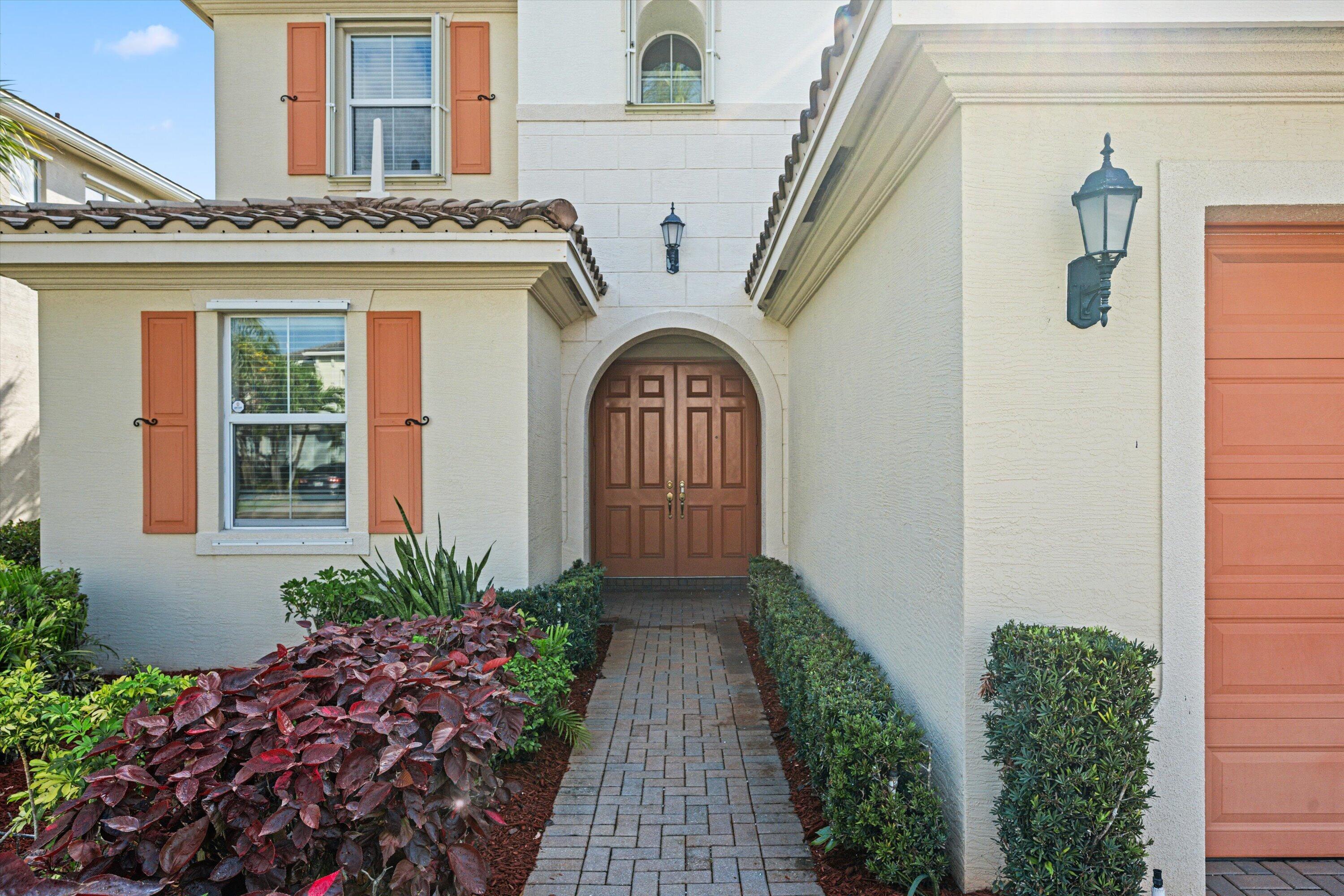 3072 Payson Way Wellington, FL 33414 - Photo 3 of 43 a view of entryway with a flower garden