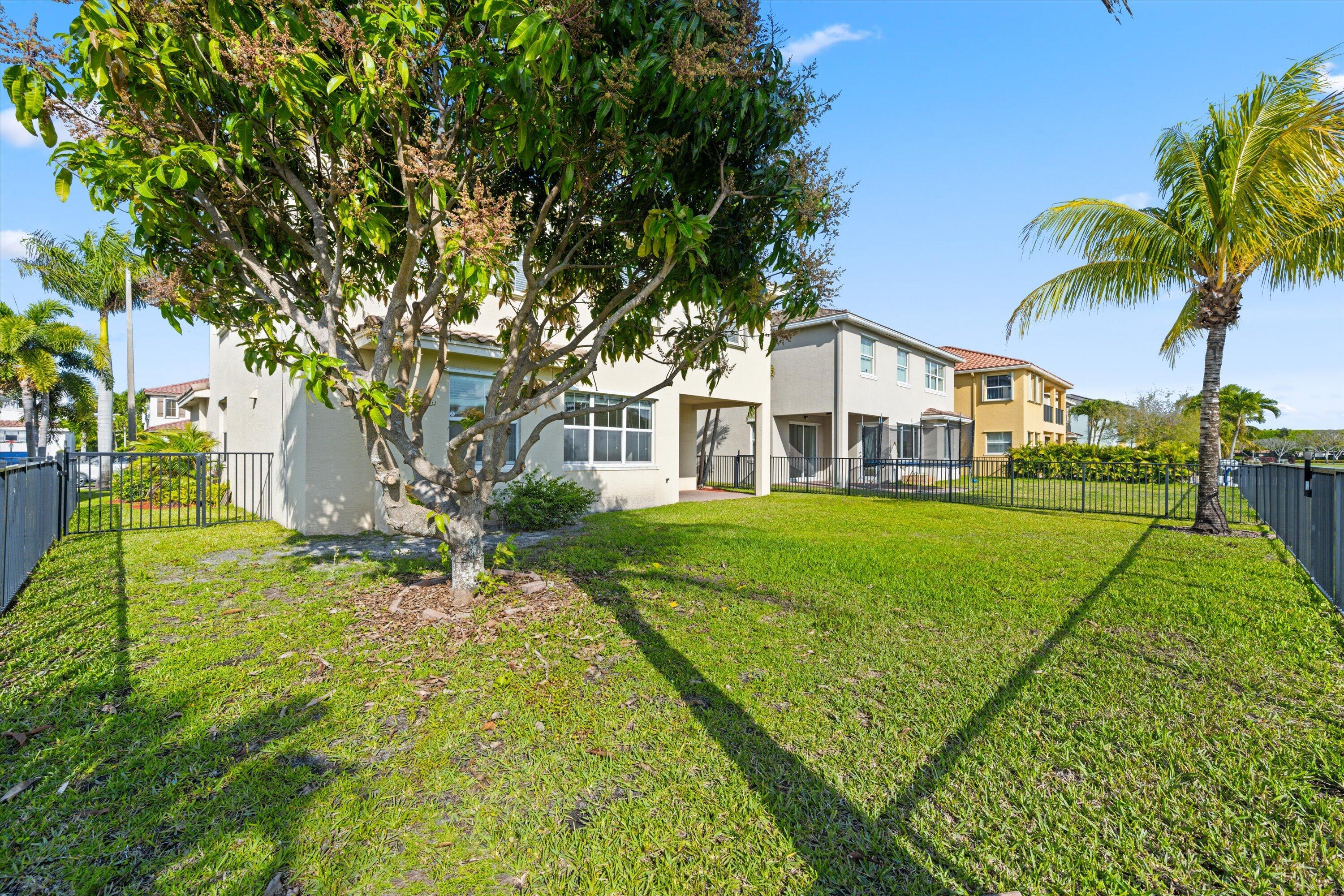 3072 Payson Way Wellington, FL 33414 - Photo 31 of 43 a house view with a garden space