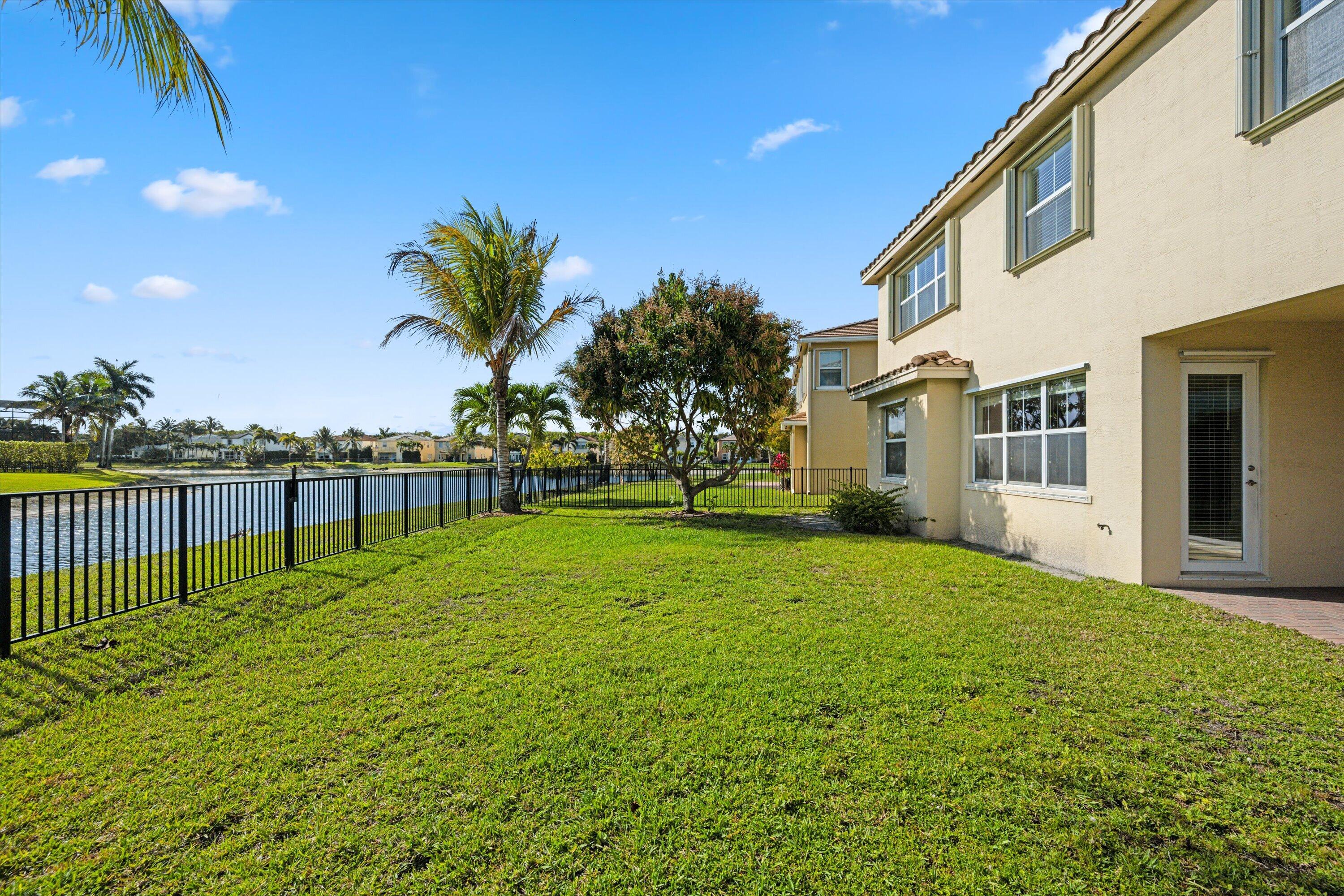 3072 Payson Way Wellington, FL 33414 - Photo 33 of 43 a view of a house with backyard and trees