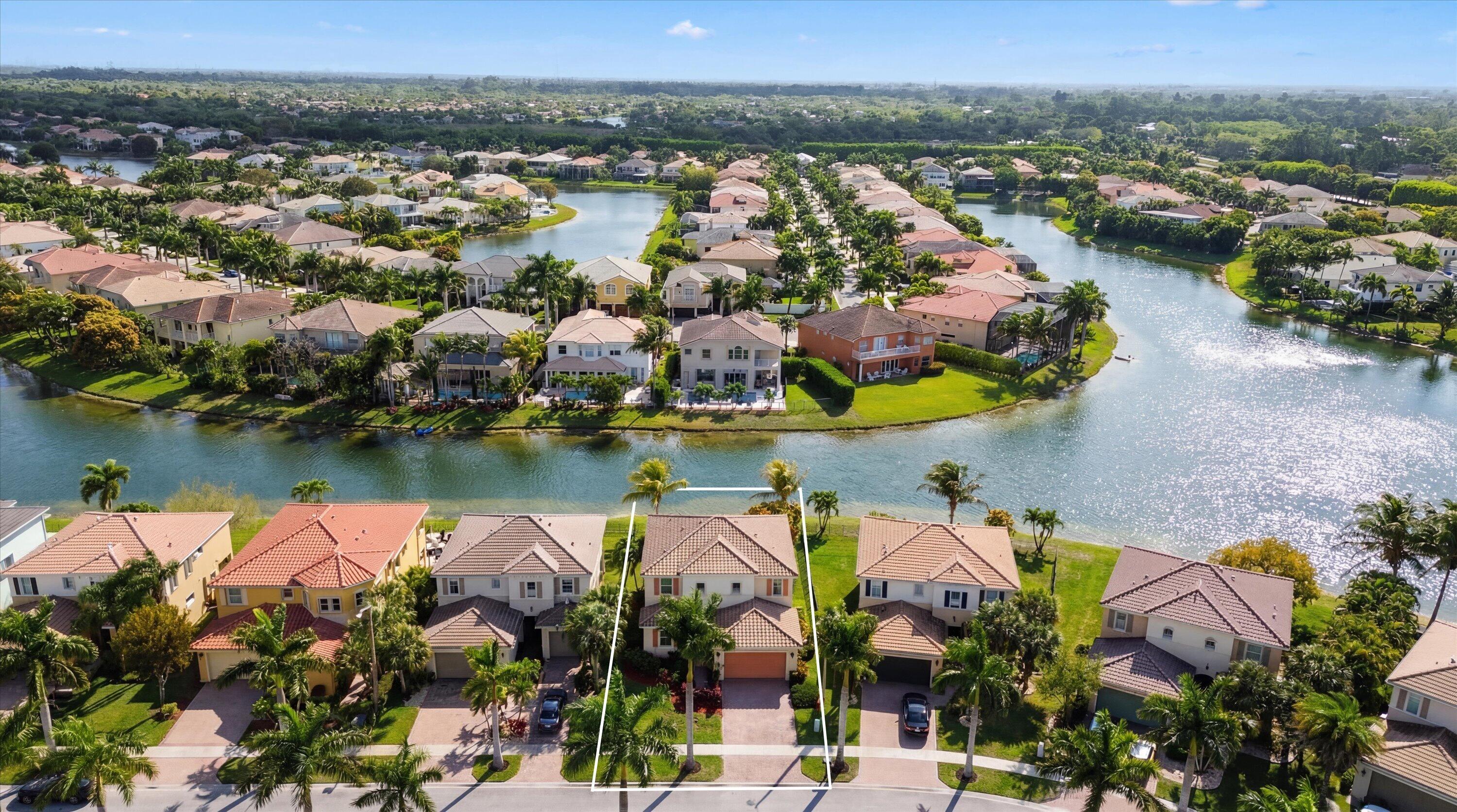 3072 Payson Way Wellington, FL 33414 - Photo 42 of 43 an aerial view of residential houses with outdoor space and lake view