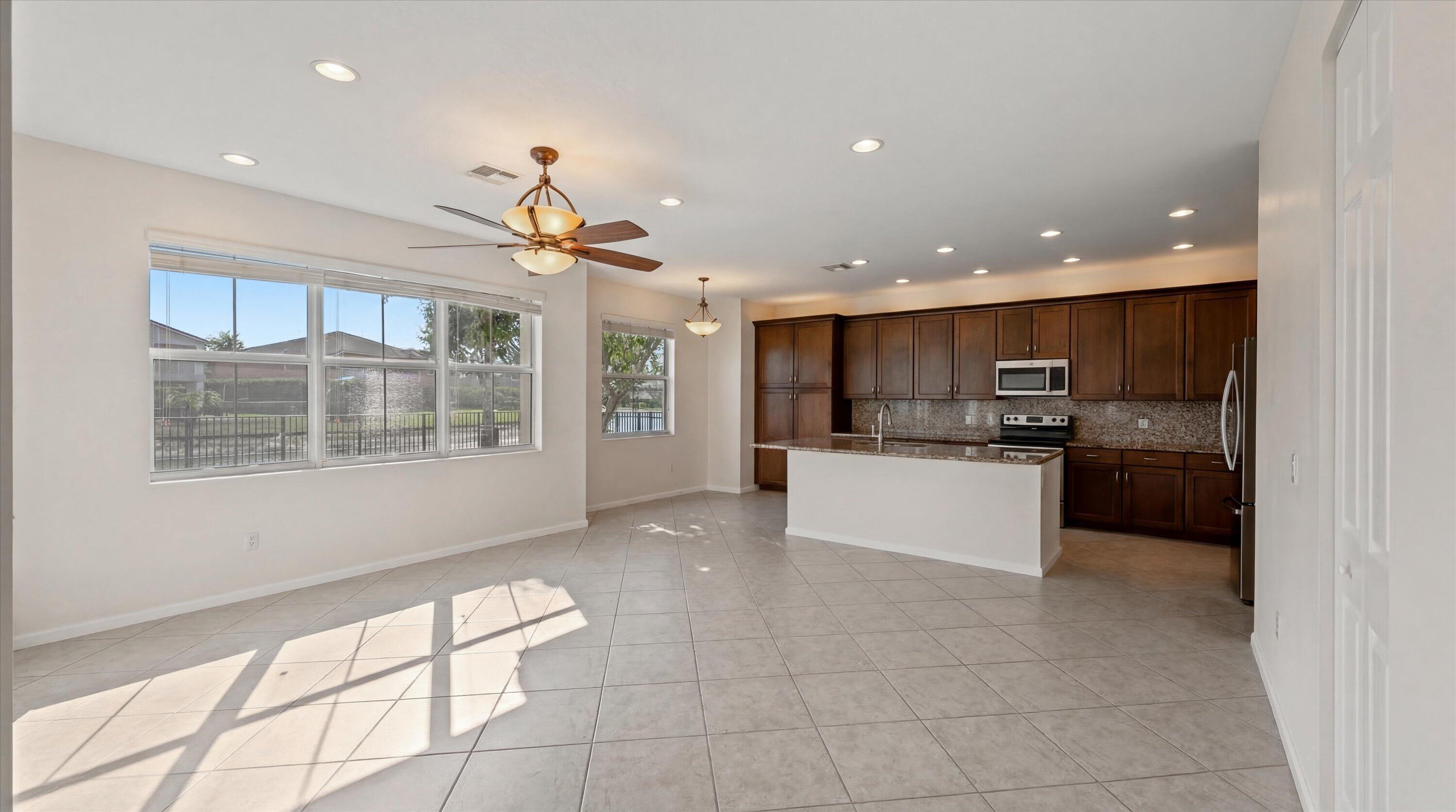 3072 Payson Way Wellington, FL 33414 - Photo 5 of 43 a kitchen with a refrigerator and a stove top oven