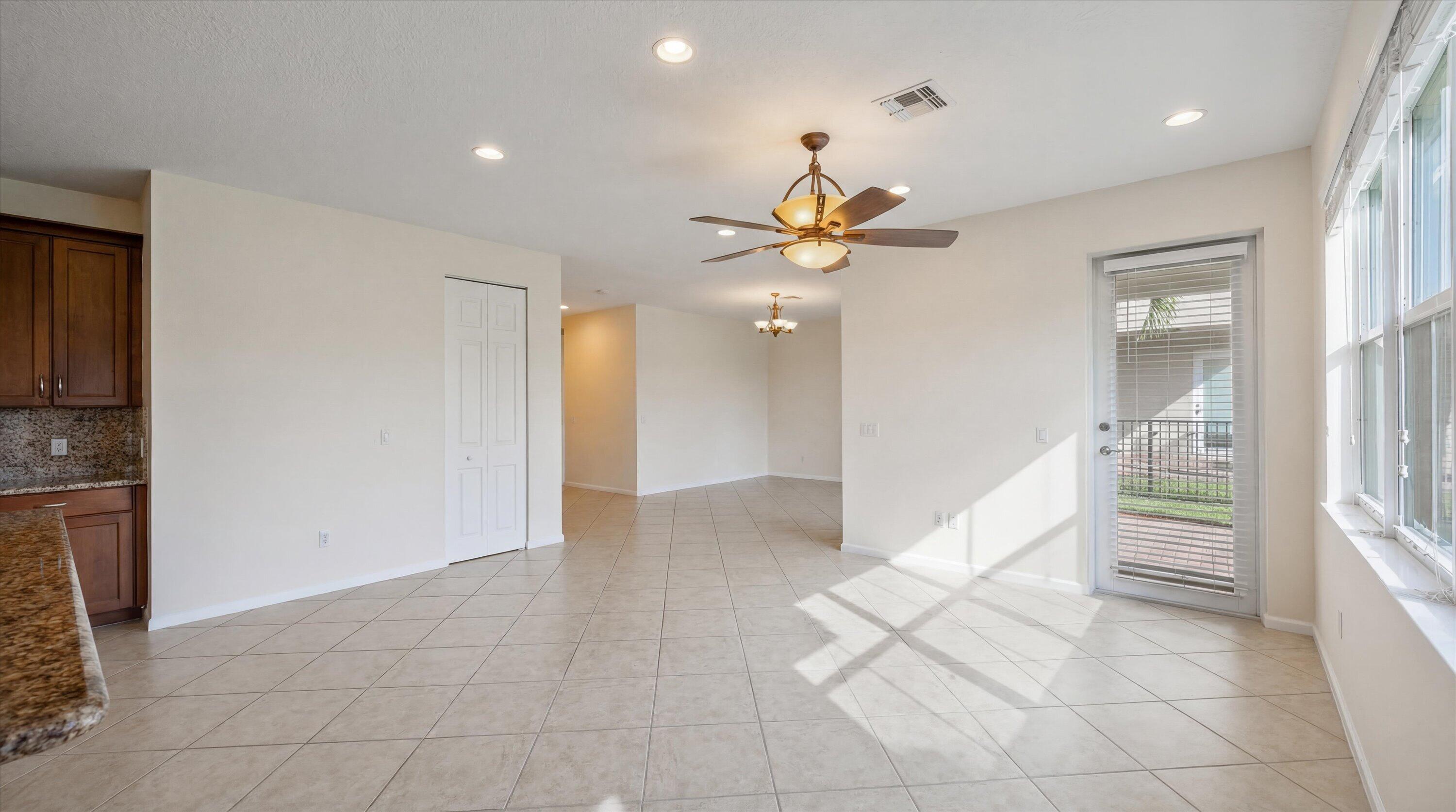 3072 Payson Way Wellington, FL 33414 - Photo 6 of 43 wooden floor in an empty room with a window