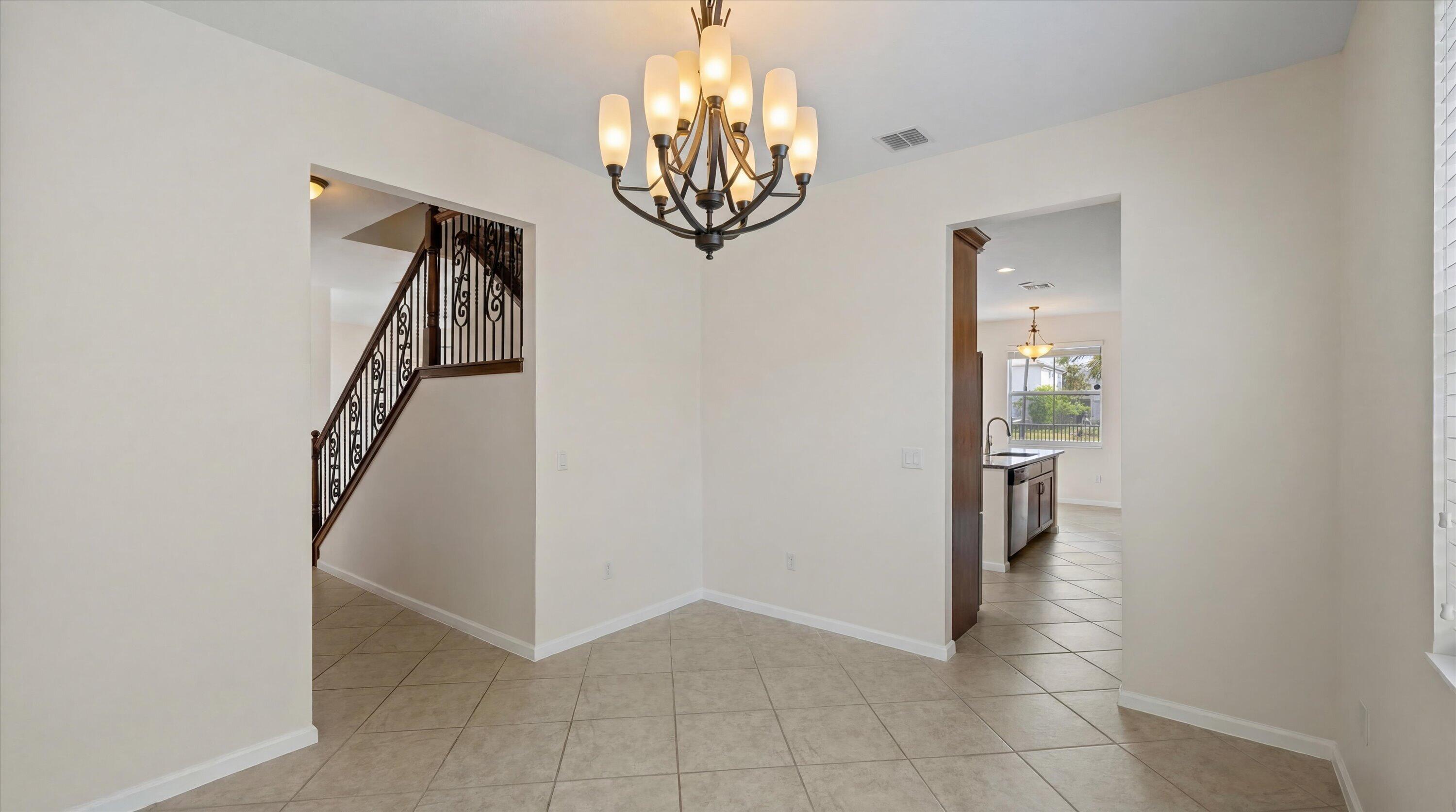 3072 Payson Way Wellington, FL 33414 - Photo 10 of 43 a view of entryway with chandelier