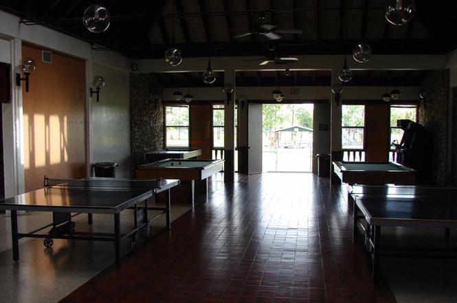730 South Willow Street Clewiston, FL 33440 - Photo 8 of 8 a dining room with wooden floor a chandelier a wooden table and chairs