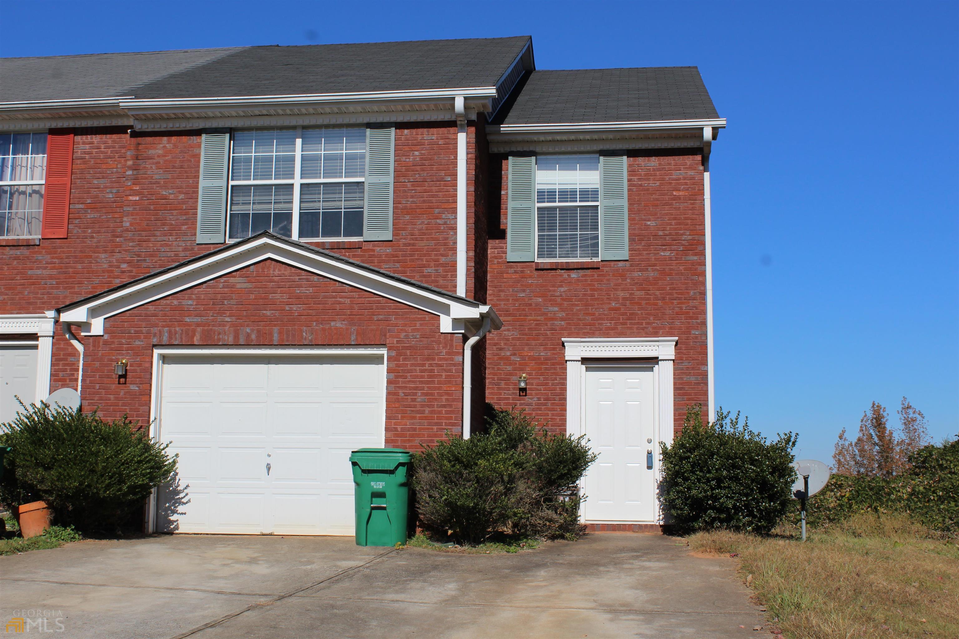 5666 Wind Gate Lane Lithonia, GA 30058 - Photo 1 of 1 a front view of a house with garden