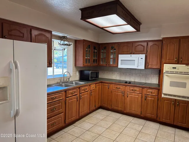 a kitchen with stainless steel appliances granite countertop a refrigerator sink and cabinets