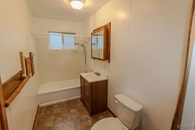 a bathroom with a toilet a sink and bathtub