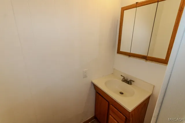 a bathroom with a sink a mirror and vanity