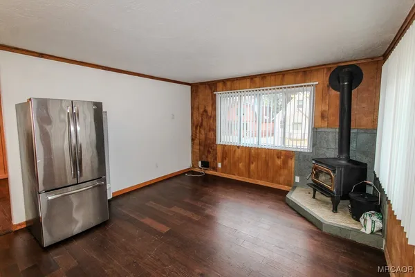 a view of a room with wooden floor and windows