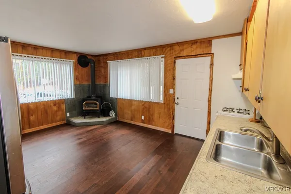 a view of a room with wooden floor and a sink