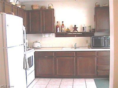9630 Zimmerman Road Homerville, OH 44235 - Photo 2 of 9 The spacious 10x22' eat-in kitchen has a sliding glass door that leads to the covered back deck.