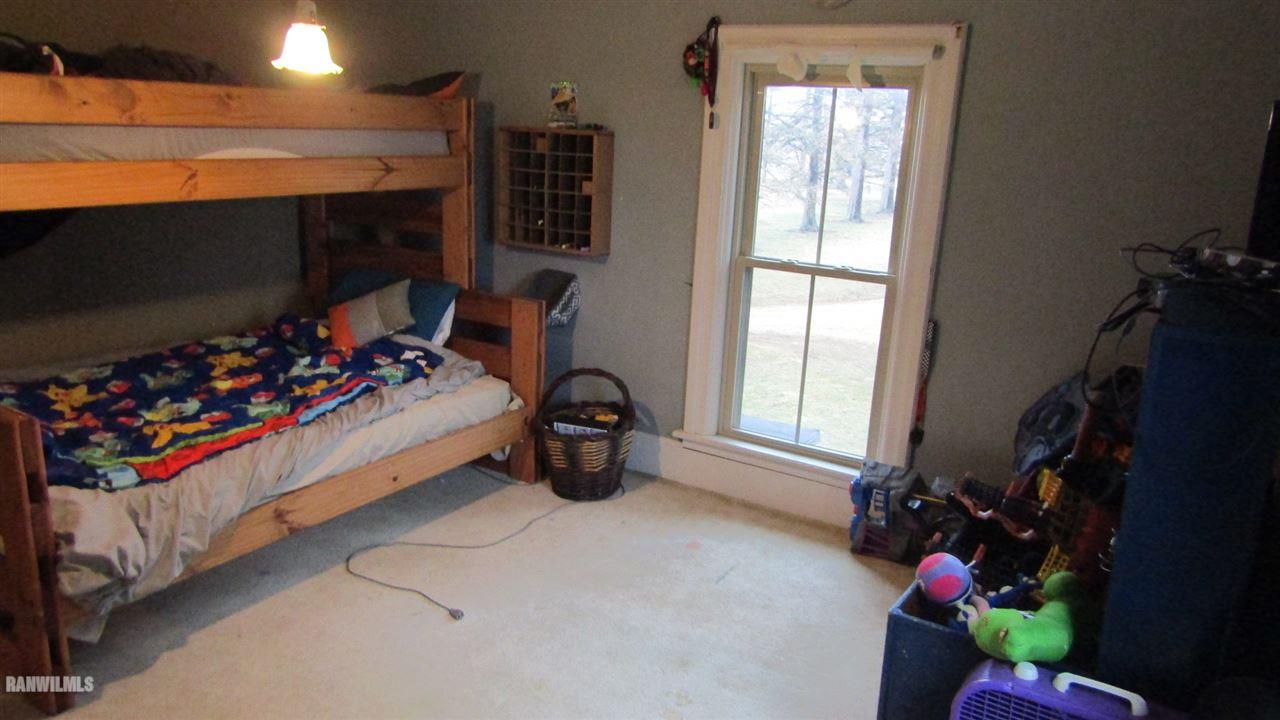 11693 Maple Grove Road Lanark, IL 61046 - Photo 13 of 19 a bed room with a bed and a window