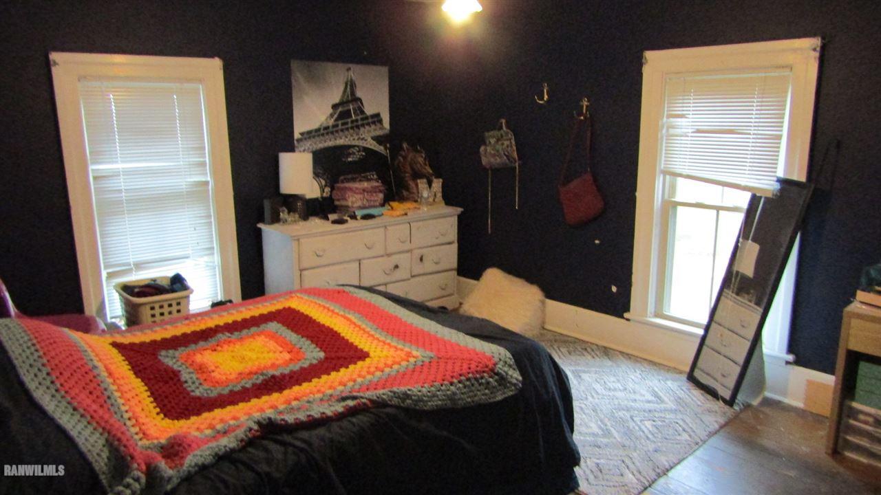 11693 Maple Grove Road Lanark, IL 61046 - Photo 14 of 19 a bedroom with a bed and dresser with mirror