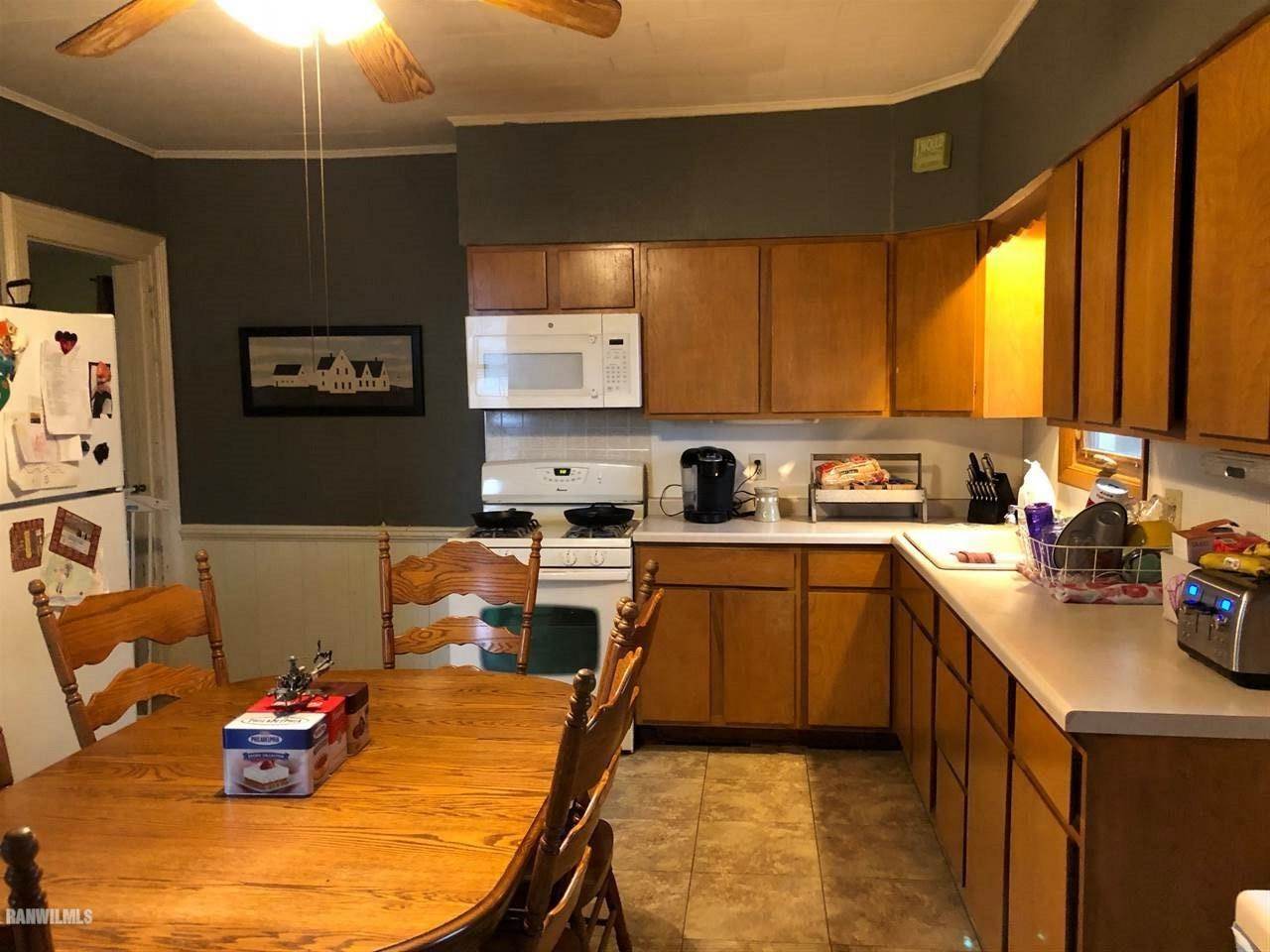 11693 Maple Grove Road Lanark, IL 61046 - Photo 2 of 19 a kitchen with stainless steel appliances granite countertop a sink dishwasher and a stove with wooden floor